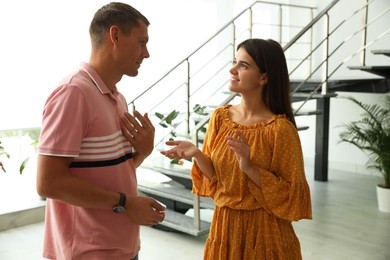 Man and woman having conversation in hall