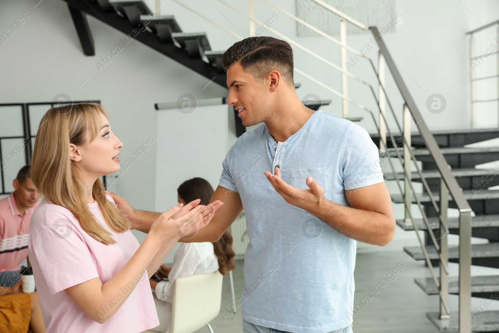 Photo of Man and woman having conversation in hall