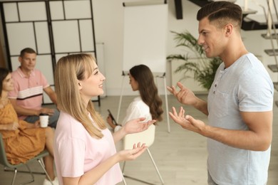 Man and woman having conversation in room