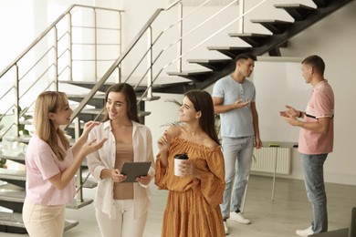 Photo of Group of women having conversation in hall