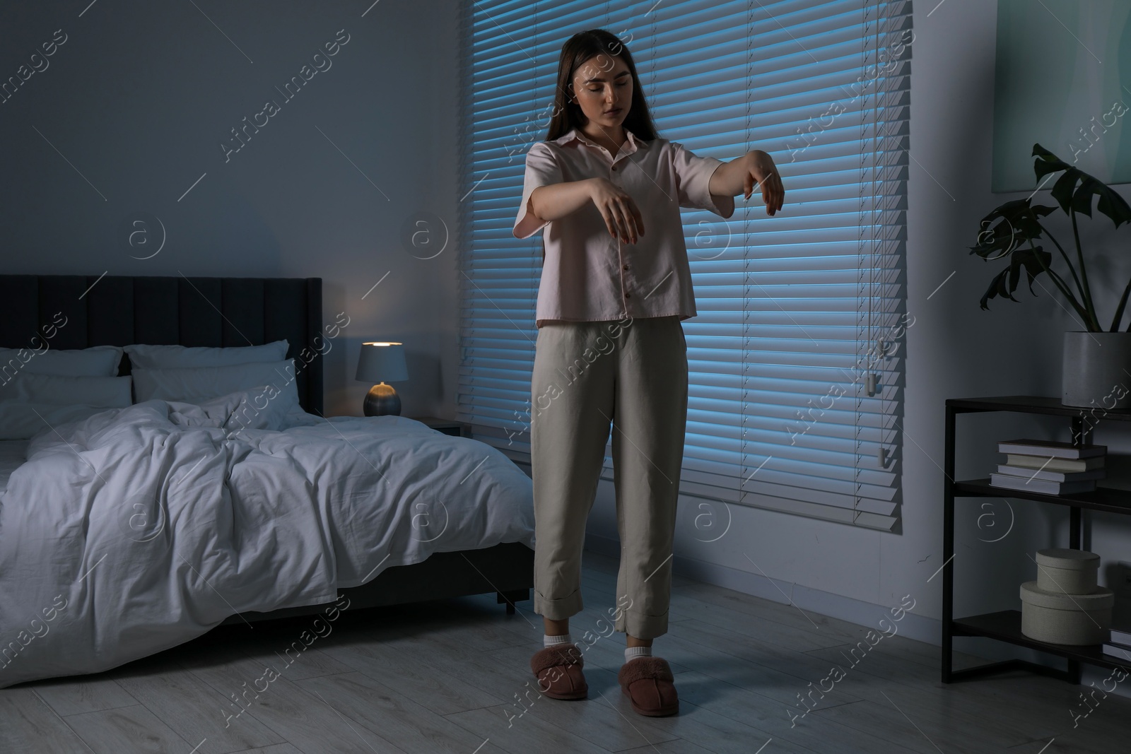 Photo of Young woman suffering from sleepwalking at home