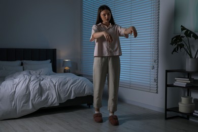 Photo of Young woman suffering from sleepwalking at home