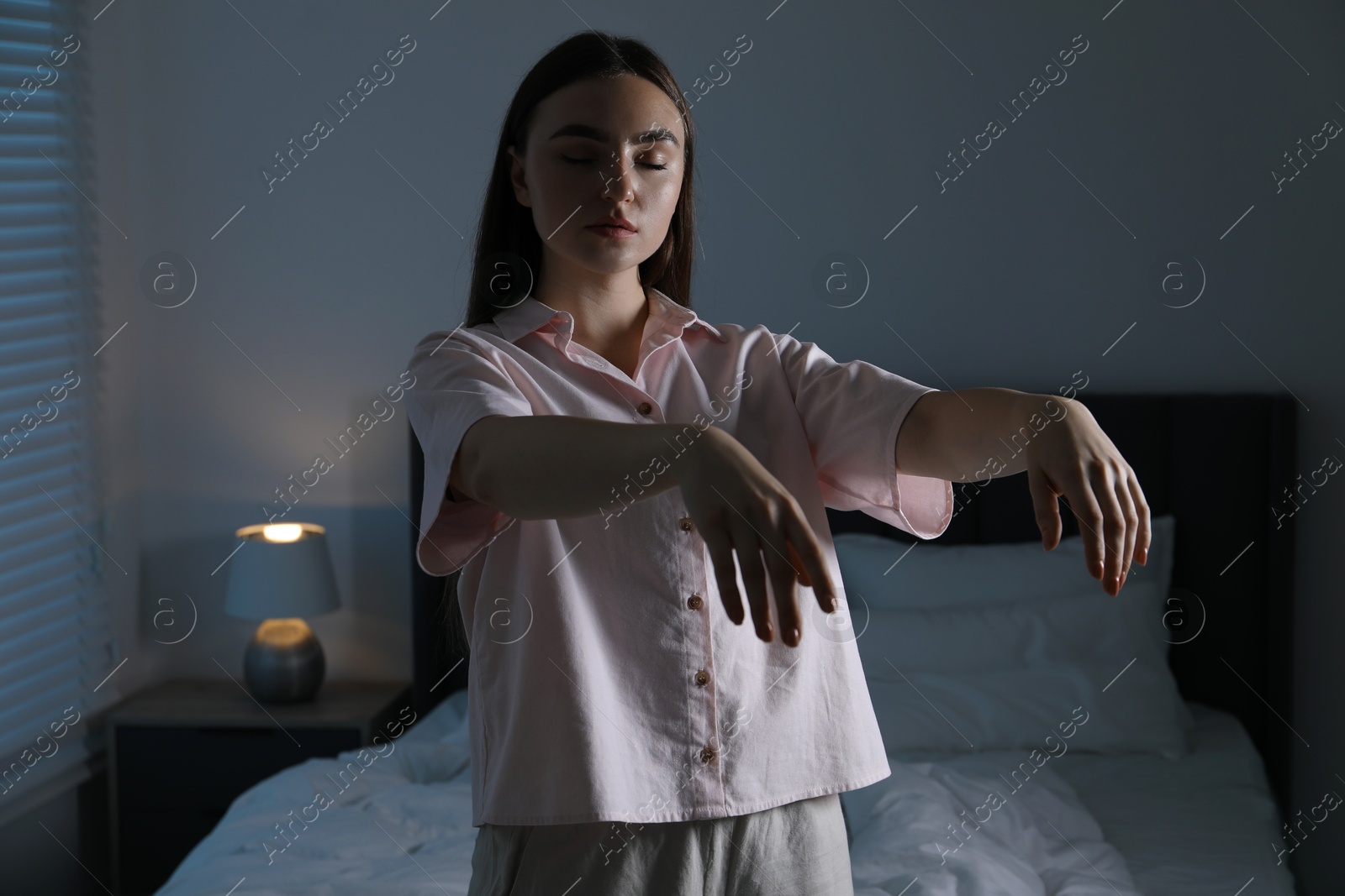 Photo of Young woman suffering from sleepwalking at home