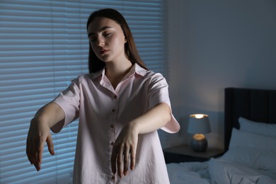 Photo of Young woman suffering from sleepwalking at home