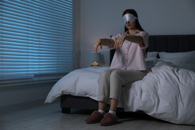 Photo of Young woman suffering from sleepwalking at home, space for text