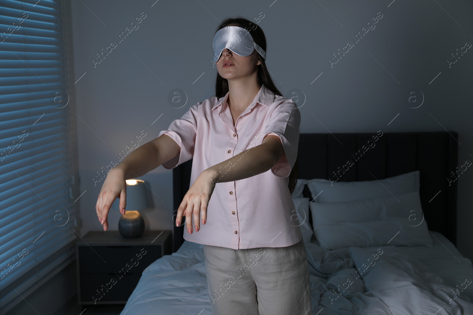 Photo of Young woman suffering from sleepwalking at home