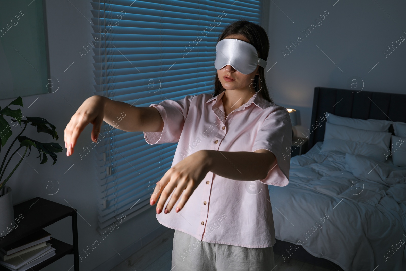 Photo of Young woman suffering from sleepwalking at home