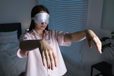 Young woman suffering from sleepwalking at home