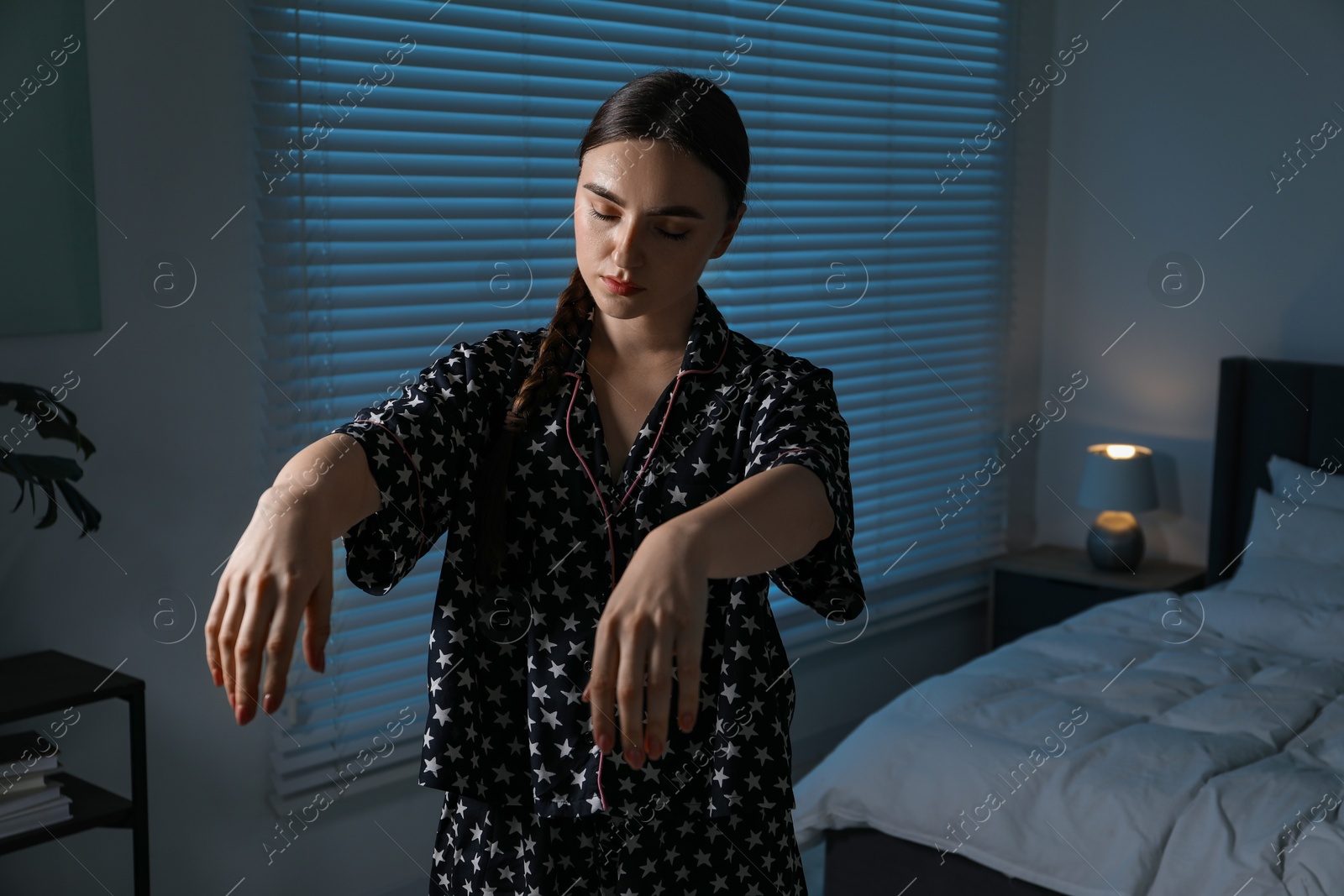 Photo of Young woman suffering from sleepwalking at home