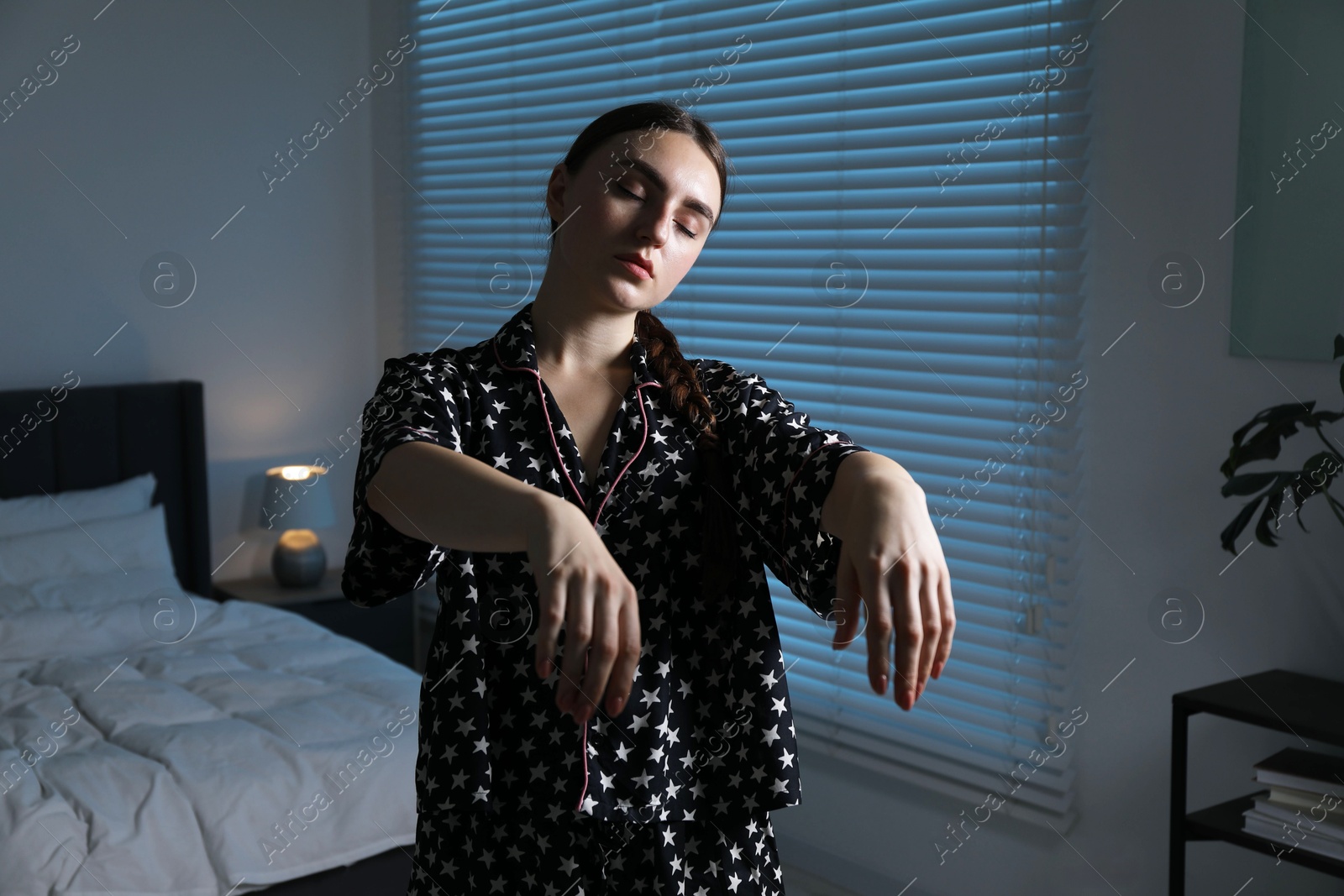 Photo of Young woman suffering from sleepwalking at home