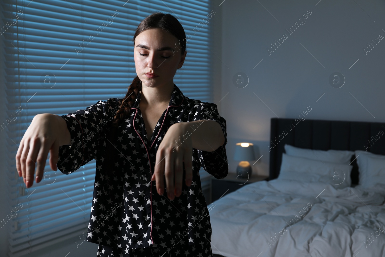 Photo of Young woman suffering from sleepwalking at home, space for text