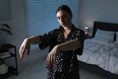 Photo of Young woman suffering from sleepwalking at home