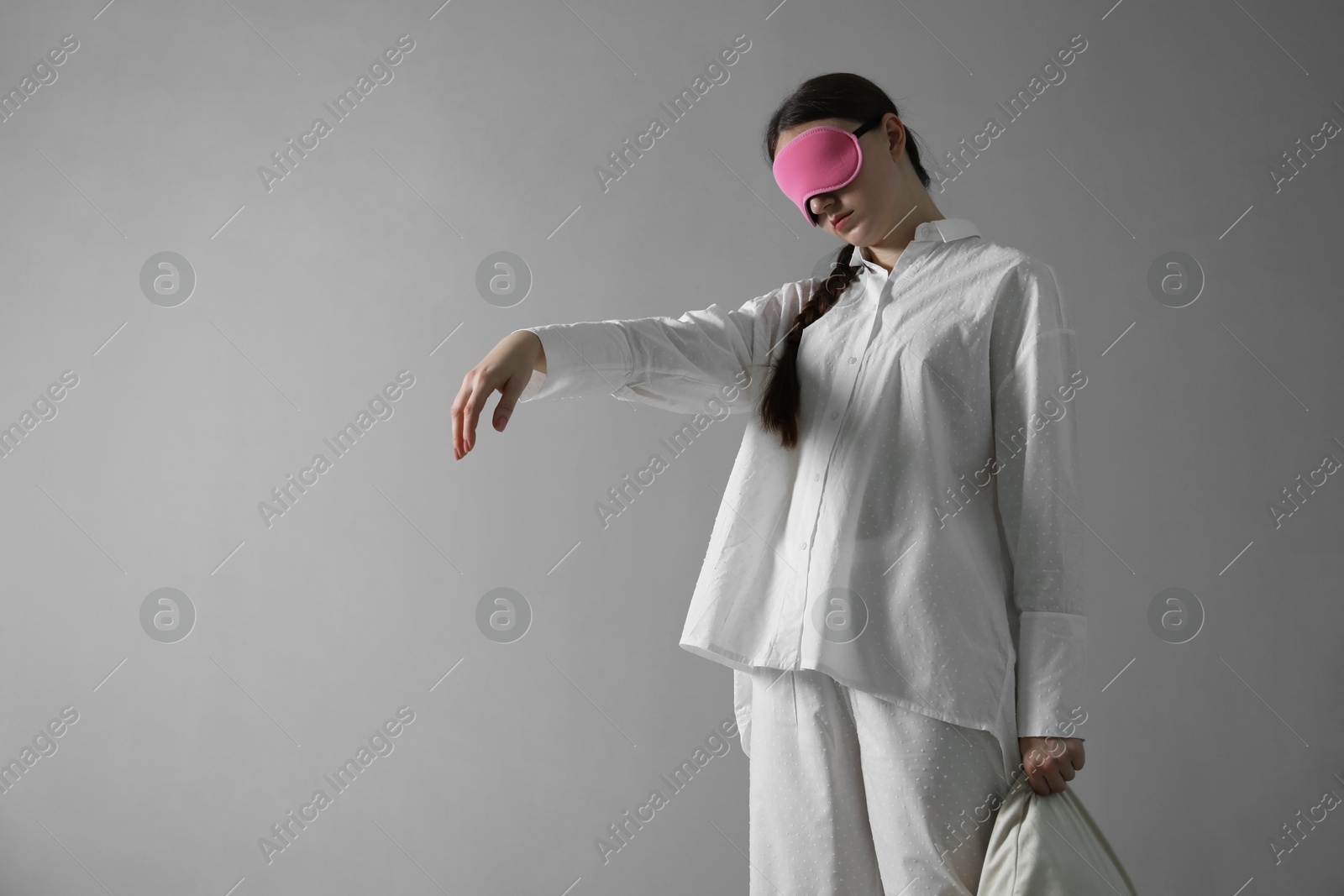 Photo of Young woman suffering from sleepwalking at home, space for text