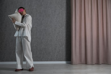 Photo of Young woman suffering from sleepwalking at home, space for text