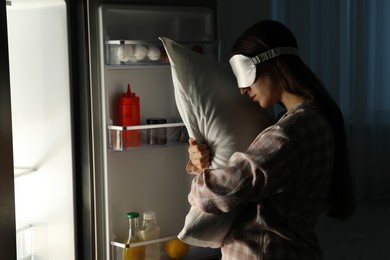 Photo of Young woman suffering from sleepwalking near fridge at home