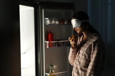 Photo of Young woman suffering from sleepwalking near fridge at home