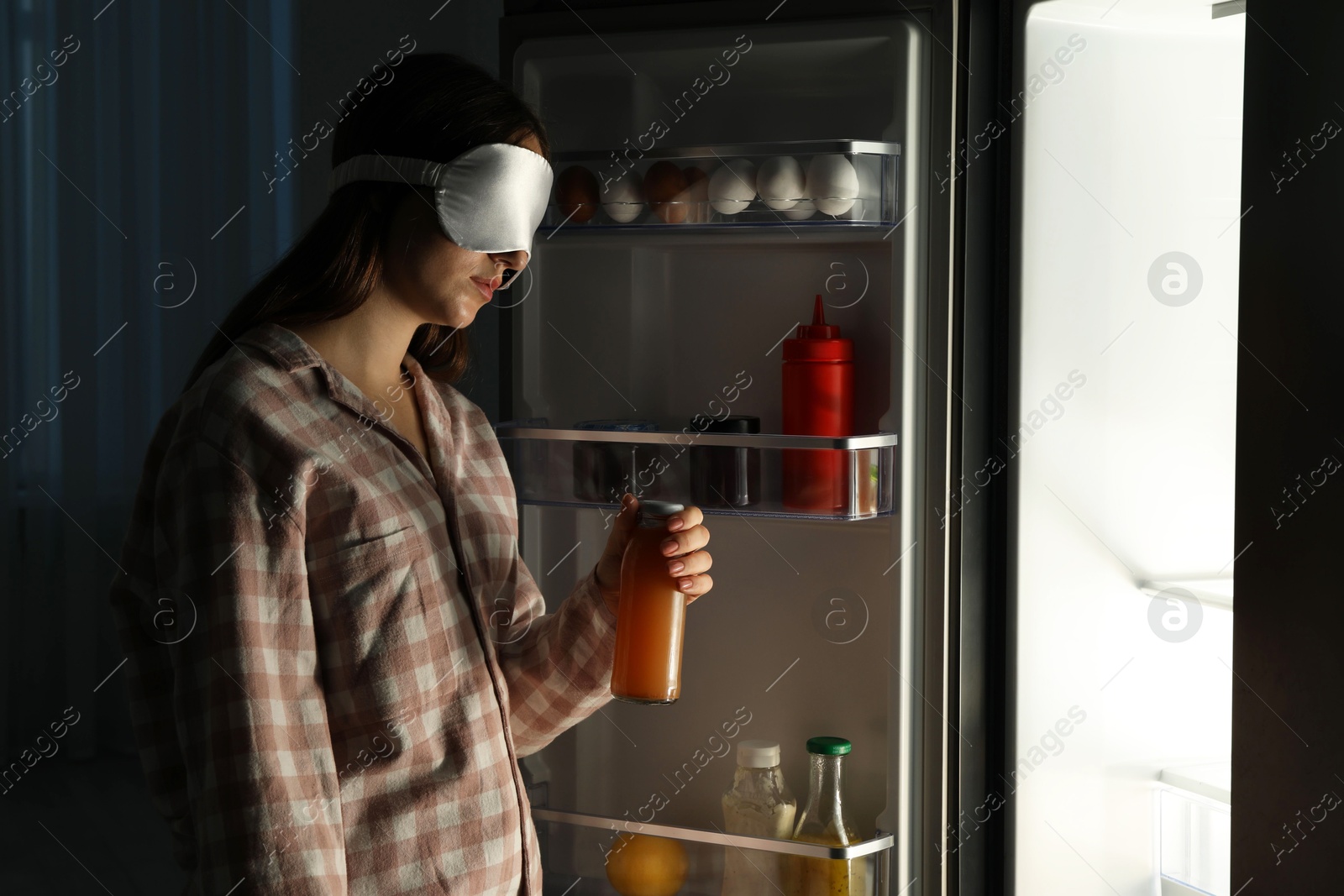 Photo of Young woman suffering from sleepwalking near fridge at home