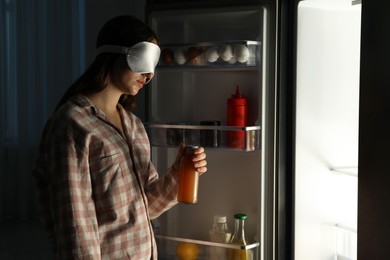 Photo of Young woman suffering from sleepwalking near fridge at home