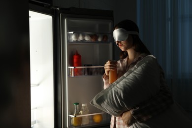 Photo of Young woman suffering from sleepwalking near fridge at home