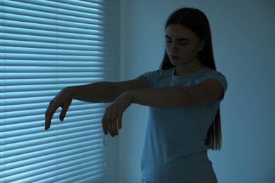 Photo of Young woman suffering from sleepwalking at home