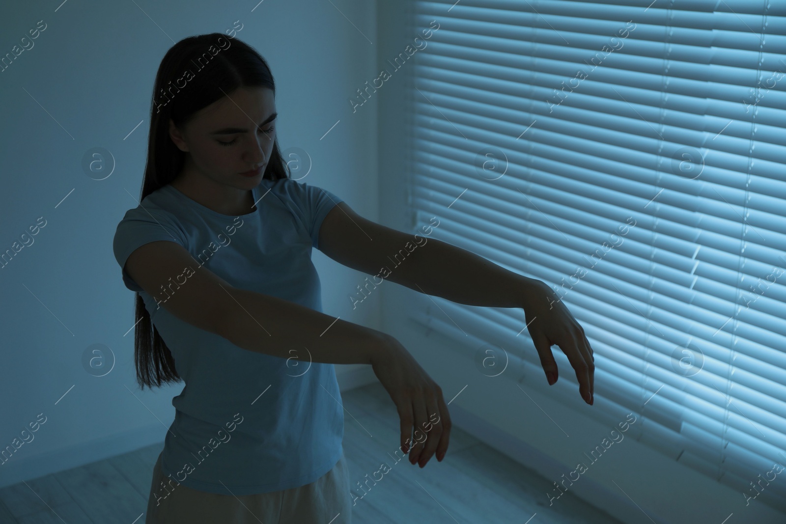 Photo of Young woman suffering from sleepwalking at home