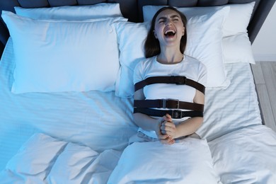 Photo of Woman in sleepwalking condition screaming in bed, above view