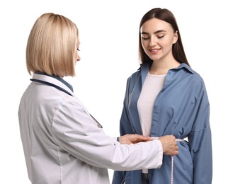 Weight loss. Nutritionist measuring patient's waist with tape on white background