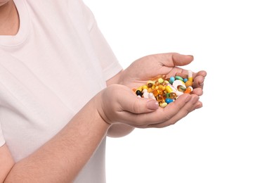 Photo of Plus size woman holding pile of weight loss supplements on white background, closeup