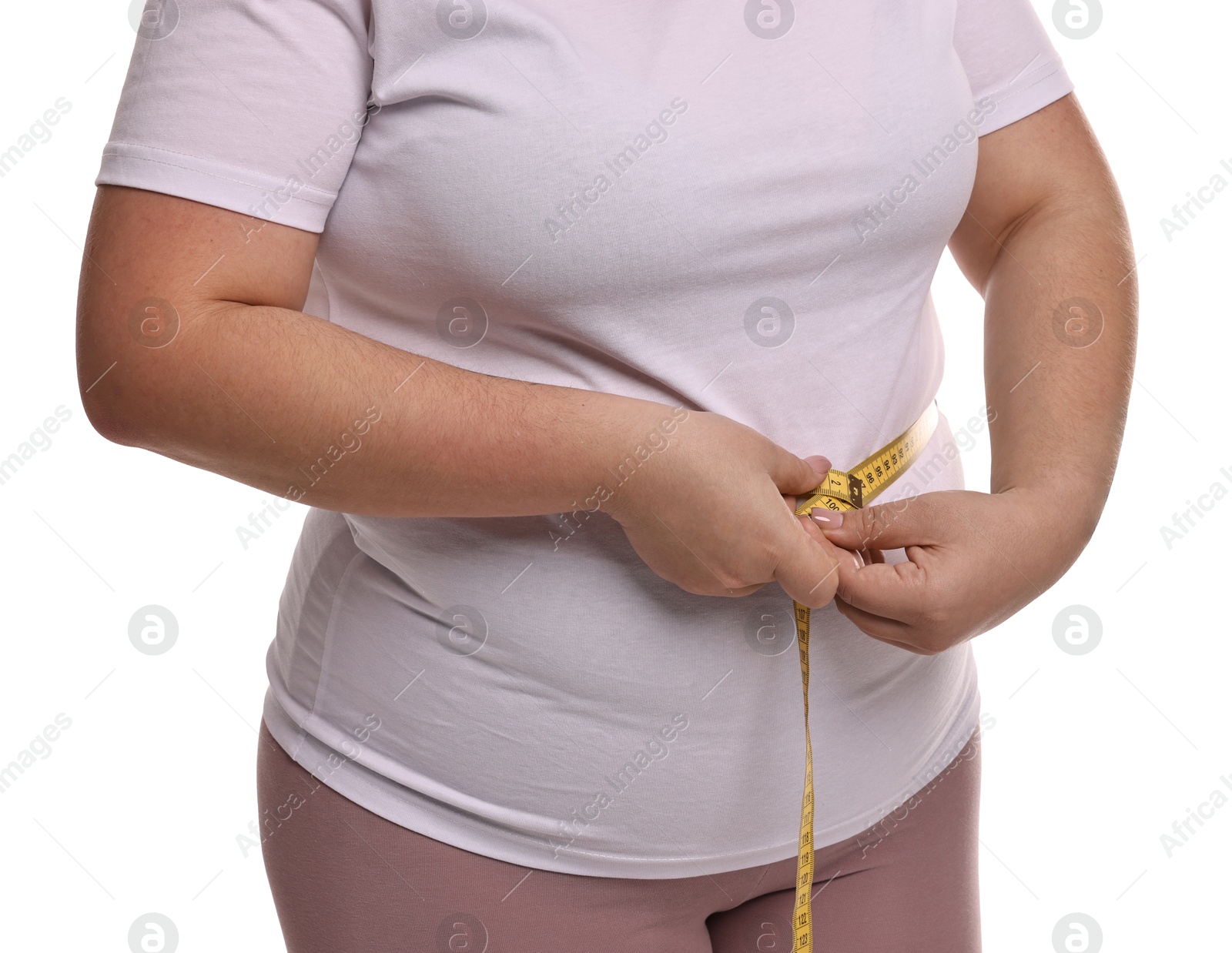 Photo of Weight loss. Plus size woman measuring waist with tape on white background, closeup