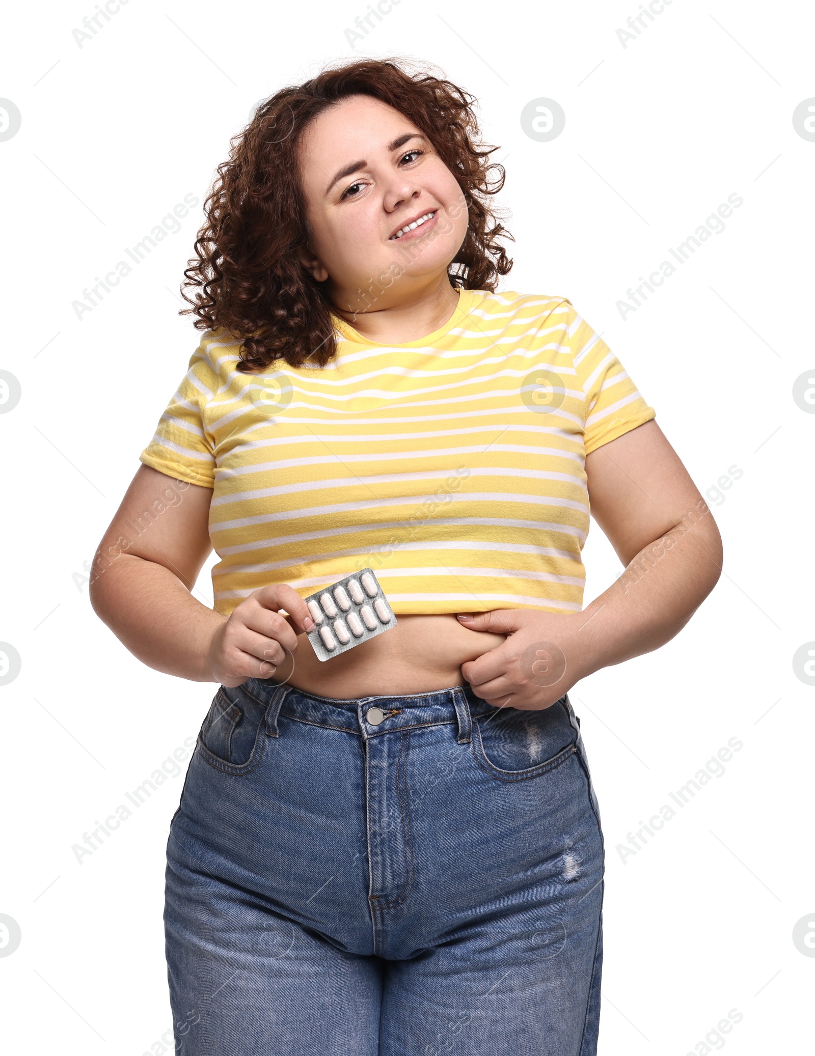 Photo of Happy plus size woman with blister of weight loss supplements on white background