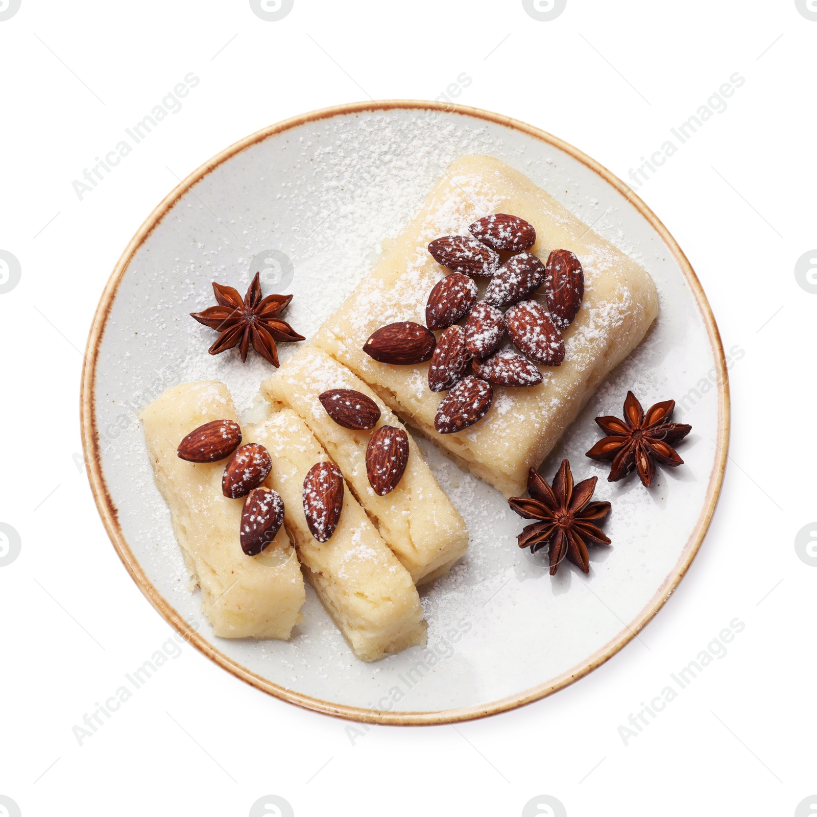 Photo of Delicious sweet semolina halva with almonds and spices isolated on white, top view