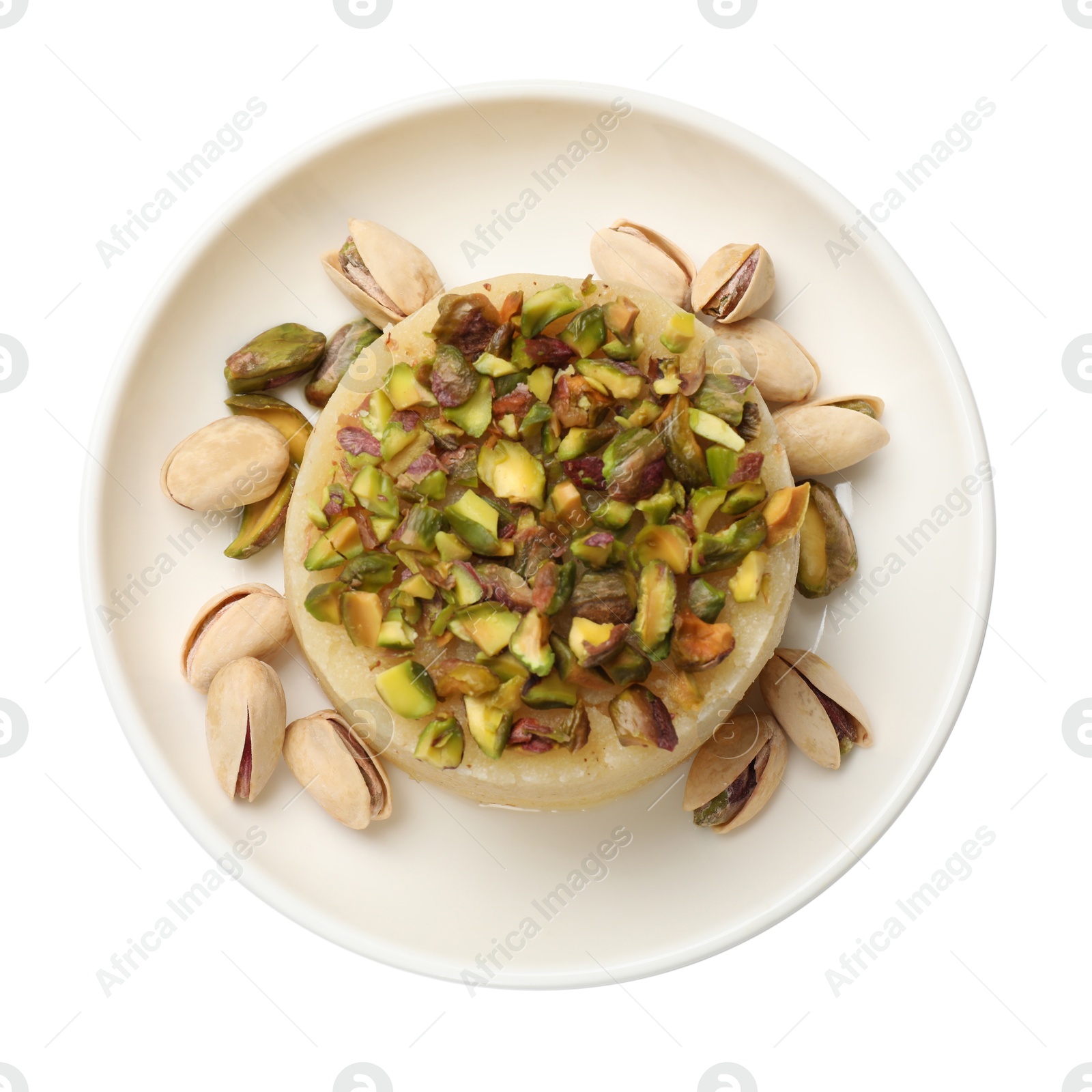 Photo of Delicious sweet semolina halva with pistachios isolated on white, top view