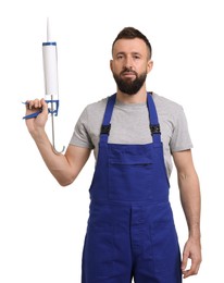 Worker with caulking gun on white background