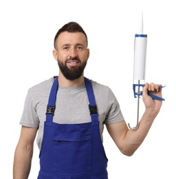 Worker with caulking gun on white background