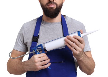 Worker with caulking gun on white background, closeup