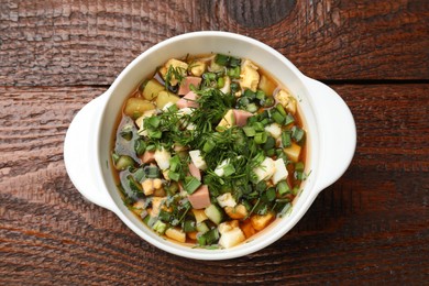 Photo of Delicious okroshka soup on wooden table, top view