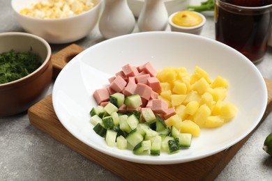 Photo of Different ingredients for okroshka soup on grey table, closeup