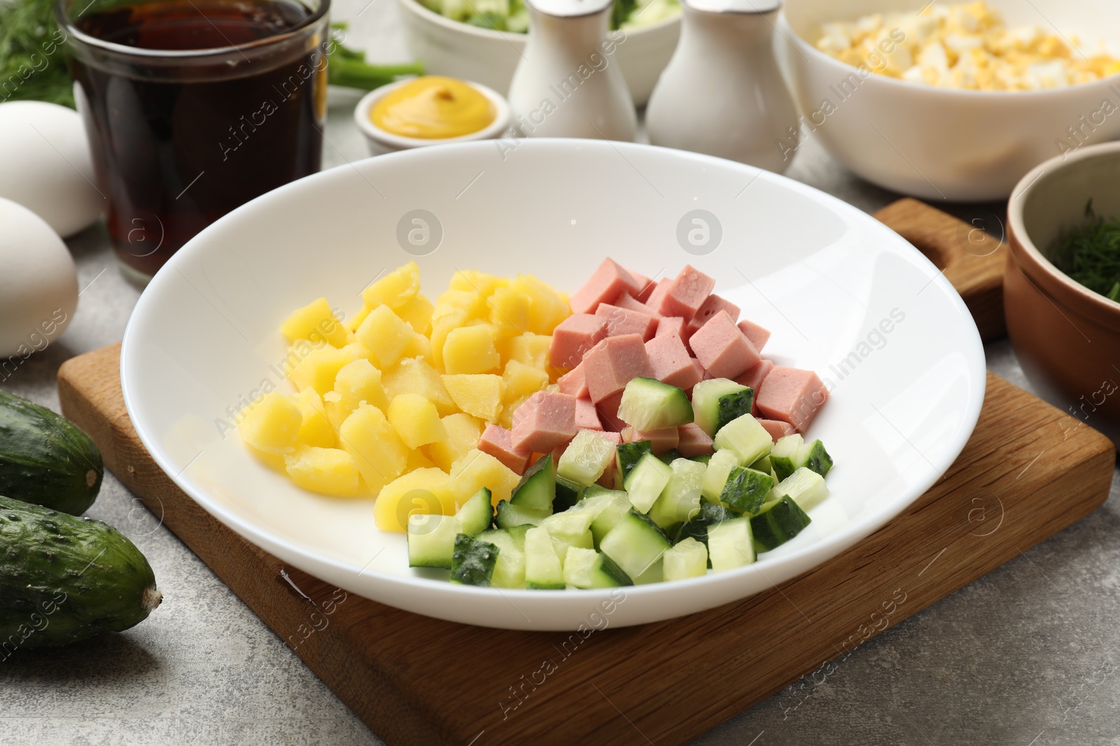 Photo of Different ingredients for okroshka soup on grey table, closeup