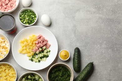 Photo of Different ingredients for okroshka soup on grey table, flat lay. Space for text