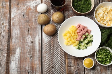 Photo of Different ingredients for okroshka soup on wooden table, flat lay. Space for text