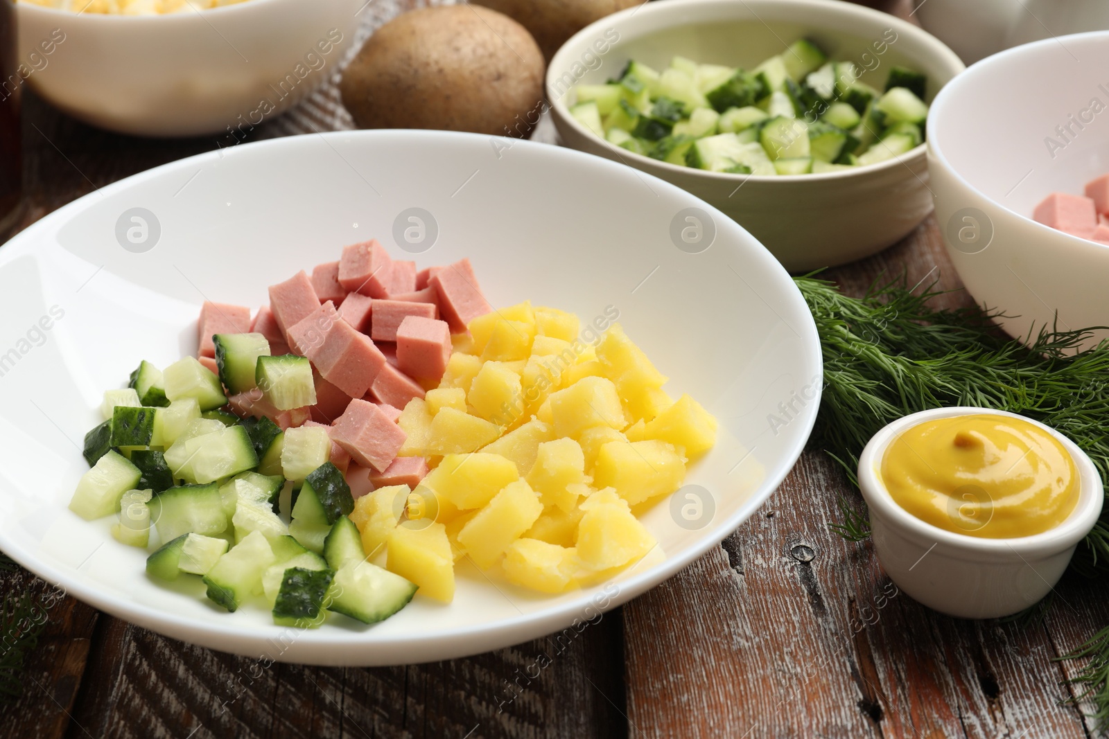 Photo of Different ingredients for okroshka soup on wooden table, closeup