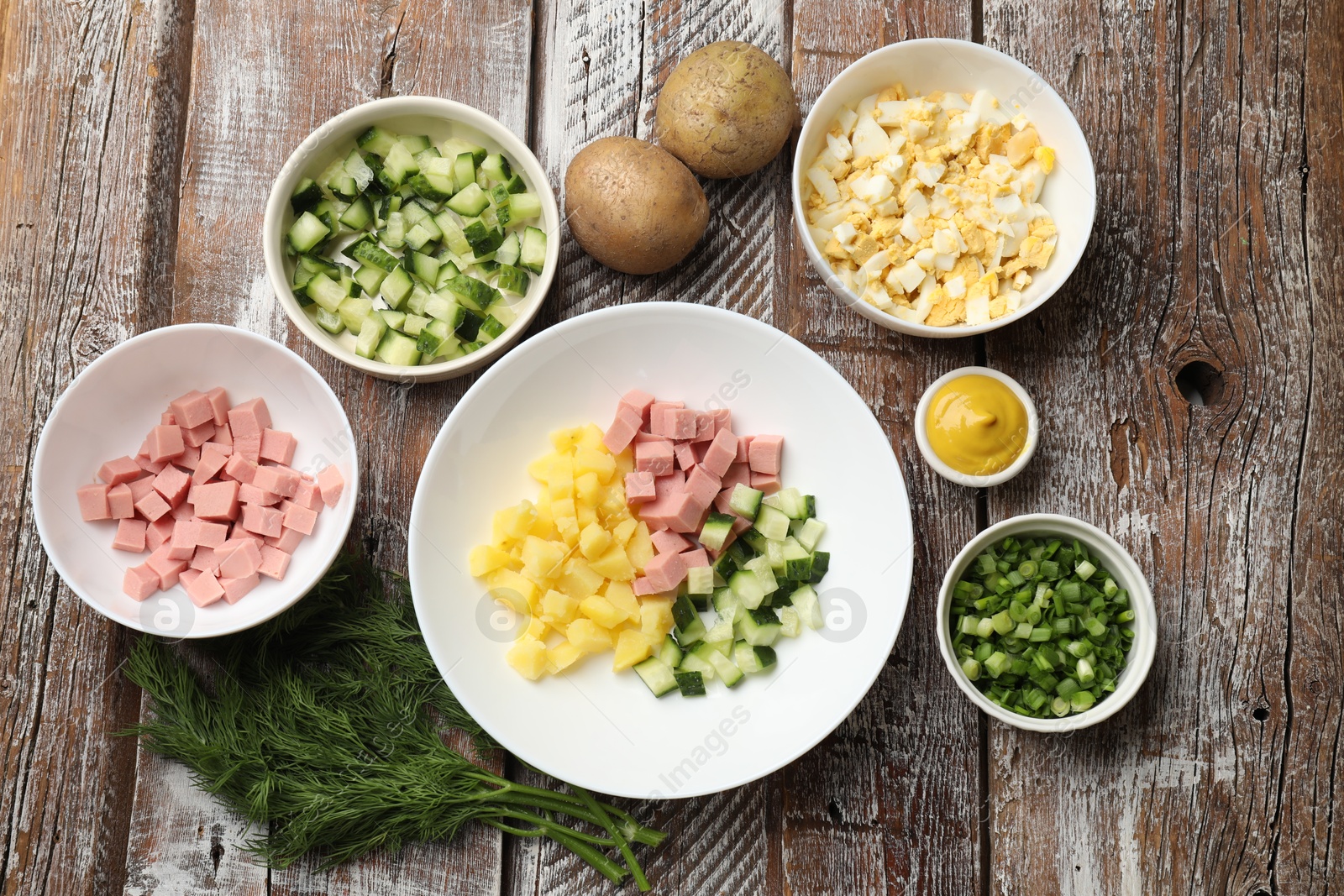 Photo of Different ingredients for okroshka soup on wooden table, flat lay