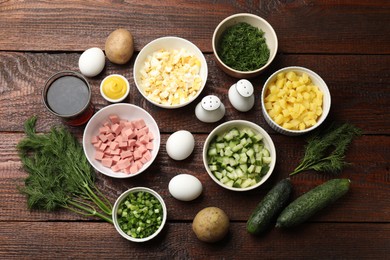 Photo of Different ingredients for okroshka soup on wooden table, flat lay