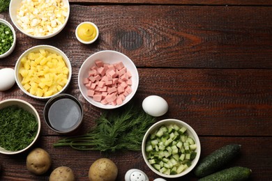 Photo of Different ingredients for okroshka soup on wooden table, flat lay. Space for text