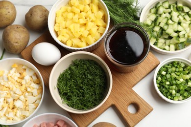 Photo of Different ingredients for okroshka soup on white table, flat lay