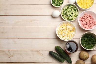 Photo of Different ingredients for okroshka soup on white wooden table, flat lay. Space for text