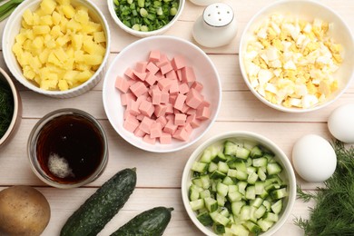 Photo of Different ingredients for okroshka soup on white wooden table, flat lay