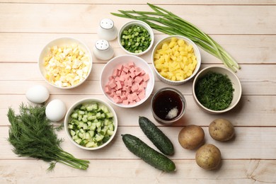 Photo of Different ingredients for okroshka soup on white wooden table, flat lay