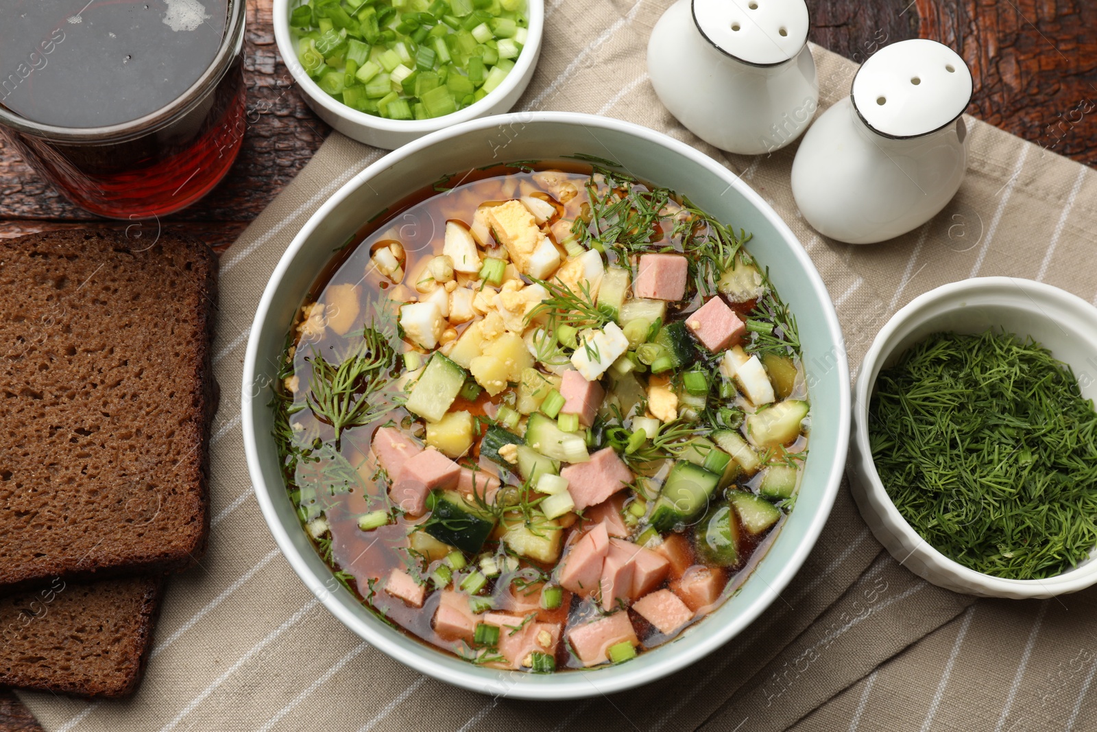 Photo of Delicious okroshka soup with kvass served on table, flat lay