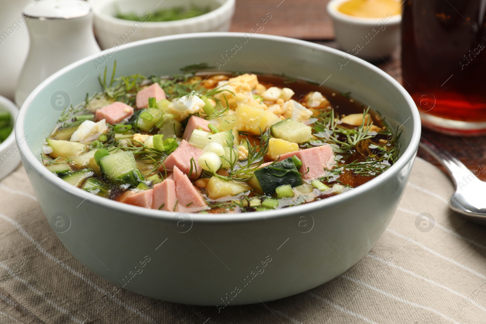 Photo of Delicious okroshka soup with kvass served on table, closeup